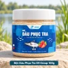 Bột Dâu Phục Tra SH Group 100g đặt chính diện trên bệ đá cạnh hồ, nhãn sản phẩm SH Group hiển thị rõ.