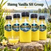 Hương Vanilla SH Group 4 Năm chai Hương Vanilla SH Group trưng bày bên hồ nước ngọt, phía trước có cốc dung dịch cùng màu.