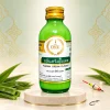 Một chai tinh mùi kem lá dứa The One 60ml trên nền ngà với họa tiết Thái và lá dứa.