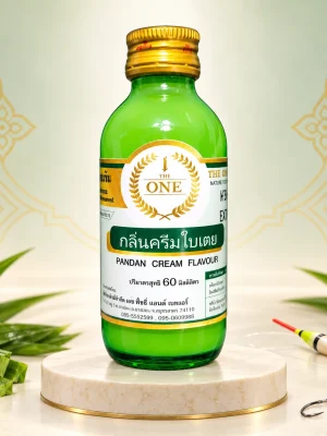 Một chai tinh mùi kem lá dứa The One 60ml trên nền ngà với họa tiết Thái và lá dứa.