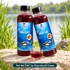 Hai chai Tinh Mùi Trái Cây Tổng Hợp SH Group, một chai đứng và một chai nghiêng khoảng 30 độ, kèm cốc dung dịch cùng màu.