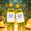 Tinh mùi Dứa (thơm) The One 60ml, hai chai, một đứng và một nghiêng với nhãn The One hướng về phía trước